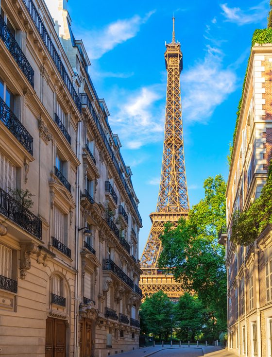 The Eiffel Tower seen from a Paris street on a sunny day